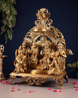Brass ram darbar idol, seated deity group beneath decorative crown-like top