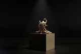 Golden brass Kali Maa idol on pedestal, side view with raised arms and jewelry