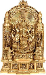 Gold-toned seated Ganesha idol with ornamental arch backdrop and musical accessories