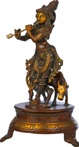 Brass Venugopala idol on circular base, flute in hand, ornate double chala styling