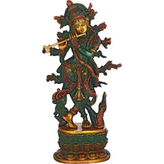 Handcrafted brass Krishna idol playing flute, green-gold attire on ornate base, 12 inch