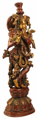 Brass Krishna statue standing on pedestal, detailed jewelry and flute at side