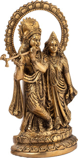 Brass Radha-Krishna idol: Krishna with flute and Radha in ornate robes, raised halo