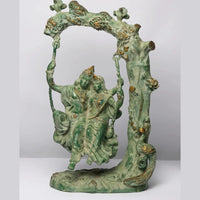 Green patina brass Radha-Krishna swing statue with ornate arch and gold accents