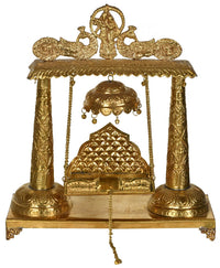 Handmade brass swing, ornate deity figure with bell-like chimes and hanging ropes