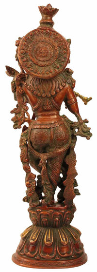 Back view of brass Krishna fluting statue with carved circular halo and ornate torso