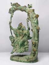 Green patina brass Radha-Krishna swing statue with seated figure on hanging swing
