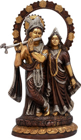Radha-Krishna brass idol with ornate crowns and gold lotus halo accents