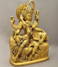 Gold brass Shiva-Parvati statue from side, seated with raised hands and trident-like pose
