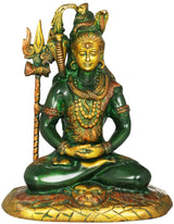 Green and gold seated Shiva brass statue with trident, ornate base and tiger-skin pattern