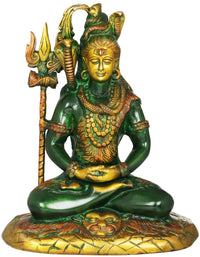 Green and gold seated Shiva brass statue with trident, ornate base and tiger-skin pattern