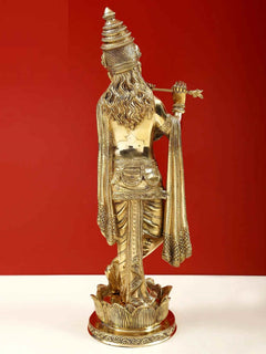 Brass Krishna flute statue back view, flowing hair and draped sash on lotus pedestal