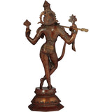 Brass Krishna deity statue with tall crown and two raised arms, on round base