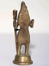 Small brass Lord Shiva statue rear view, hooded figure with raised hands, on round base