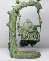Green patina brass Radha-Krishna swing statue, close view of arch and swing seat