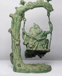 Green patina brass Radha-Krishna swing statue, close view of arch and swing seat