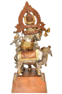Brass Krishna statue on cow, decorative arch back, 13 inches