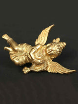 Small brass idol of Lord Gandharva in a reclining pose with spread wings and ornate face
