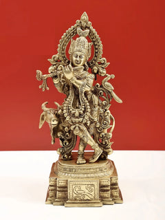 Natural brass sculpture of Venugopala holding flute, ornate crown and cow attendants