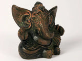 Small Ganesha figurine front view, textured face and ornamental torso