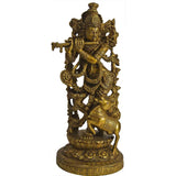 Handmade brass statue of Lord Krishna holding cow, ornate standing figure on base