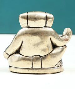 Handmade brass Ganesha good-luck statue, small 2 in, back view with tail and skirt