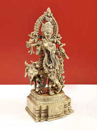 Venugopala brass sculpture with flute and raised arms, detailed jewelry and cow figure