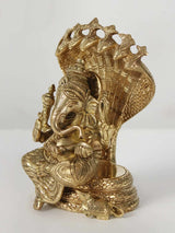 Brass Lord Ganesha statue seated on coiled Sheshnag, side view