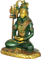 Seated Shiva idol in dark green and gold with trident staff and beaded jewelry