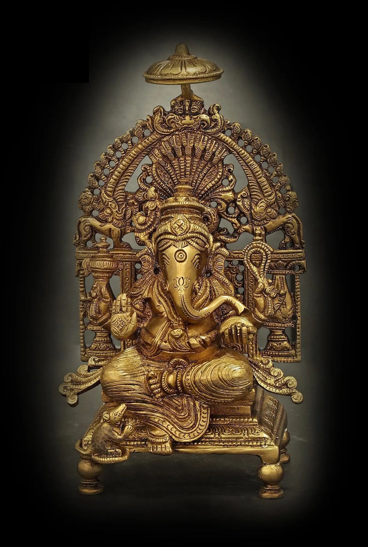 Brass Ganesha seated on ornate throne, 5-inch figurine