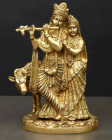 Brass Radha Krishna statue holding flute with cow figure, full view, detailed