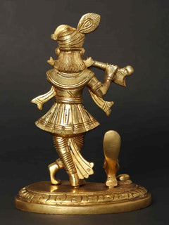 Lord Krishna flute statue, side view, gold tone, decorative base with etched pattern