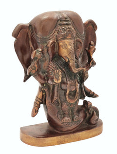 Brass Ganesha figurine with elephant head, ornate trunk and crown, side view