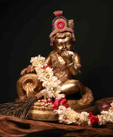 Brass Baby Krishna statue, butter thief, seated with ornate headdress and jewelry