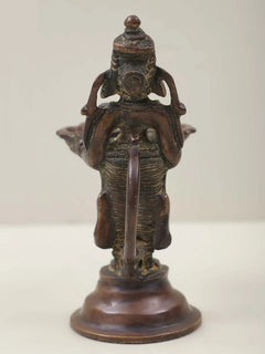 Brass Ganesha twin lamp figurine from behind, draped torso with two dish lamps