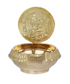 Brass puja diya with throne Ganesha on round lid and shallow bowl base