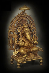 Brass Lord Ganesha seated on throne, side profile with raised trunk