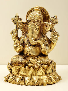 Brass Lord Ganesha figurine seated on lotus, side view showing trunk and crown