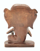 Rear view of brass Ganesha idol, elephant feet and trunk detail on base