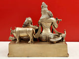 Brass Krishna and Radha statue with cow, side view on raised platform base