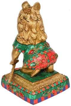 Brass Laddoo Gopala idol side view, ornate green and red patterned base and robe