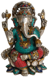 Brass Ganesha statue in teal and red mosaic, seated with trunk and raised arms