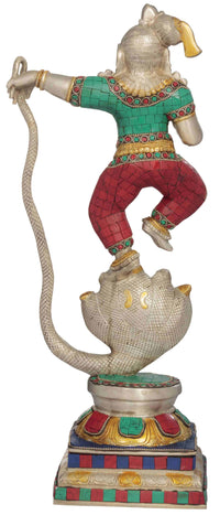 Dancing brass Shri Krishna statue, turquoise top, red patterned pants, coiled serpent