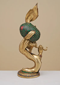 Handmade brass Krishna sculpture from side, red inlay cloak and flute raised