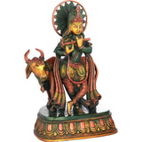 Brass Krishna statue with cow, 10 in—side view, detailed painted attire
