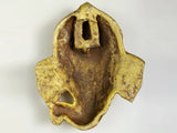 Back view of small brass Lord Ganesha wall mask with hanging slot, 4-inch