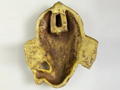 Back view of small brass Lord Ganesha wall mask with hanging slot, 4-inch