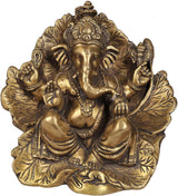 Lord Ganesha statue seated on a flower, ornate gold tone, detailed jewelry and face