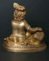 Brass Baby Krishna statue from side, detailed crown and jewelry with raised arm