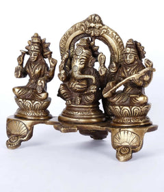 Brass triad figurines of Ganesha, Lakshmi and Sarasvati with raised arms on base